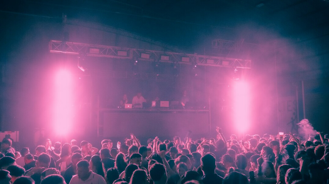Concert crowd with stage lights at a live music festival